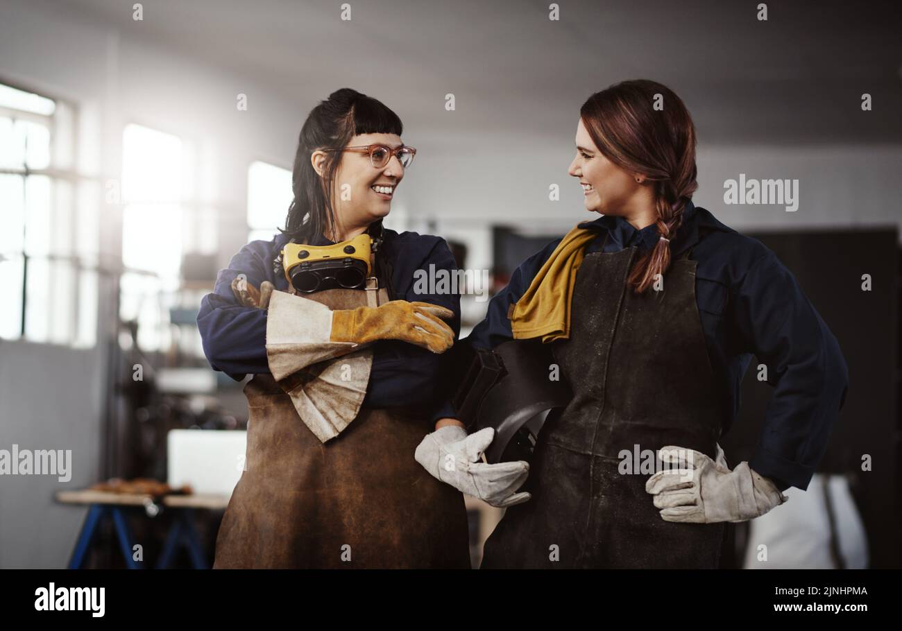 Au sommet de leur industrie, deux jeunes femmes artisans attirantes debout dans leur atelier. Banque D'Images