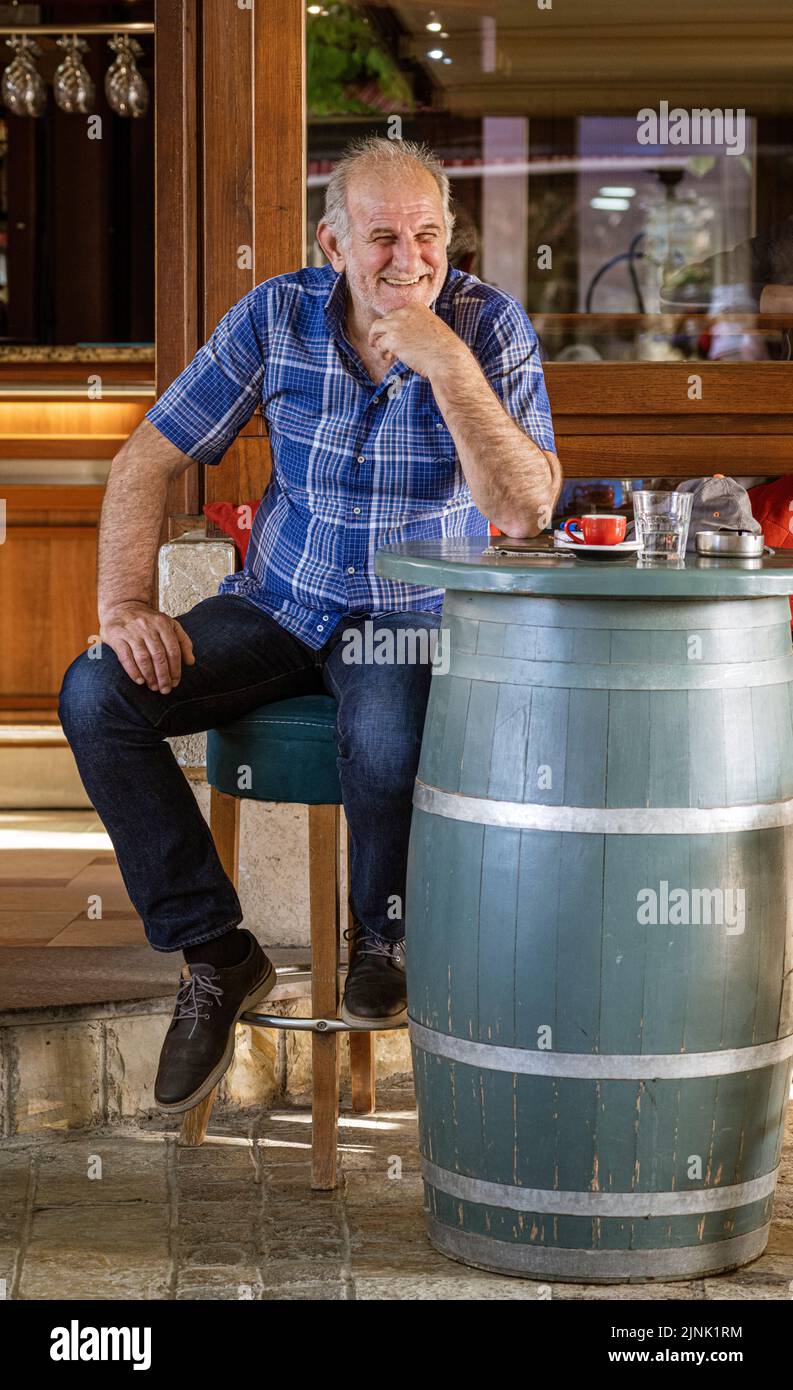 Albanie, 12 mai 2022 - l'homme est assis à une table faite de tonneau à vin, au bar extérieur. Banque D'Images