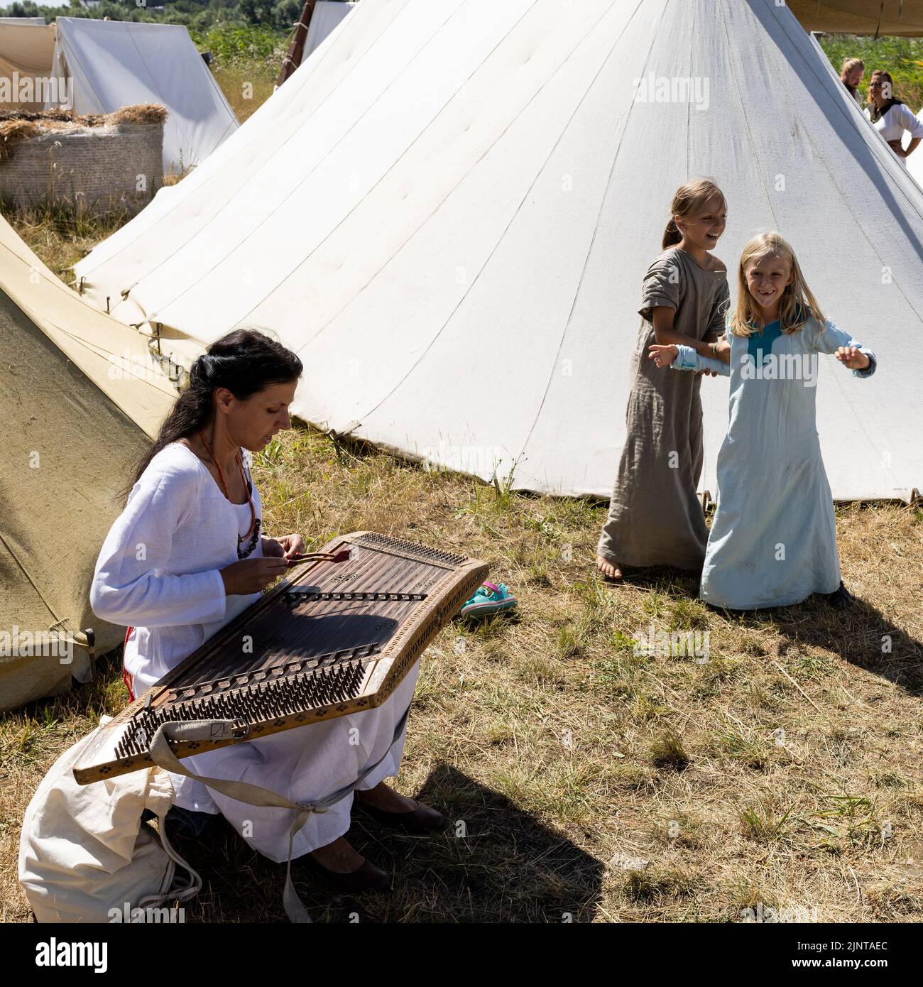 WOLIN, POLOGNE - 6 AOÛT 2022 : XXVII Festival des Slaves et Vikings, deux filles dansant à la musique jouée sur la psaltère (instrument de type harpe) Banque D'Images