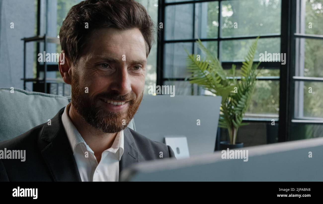 Gros plan homme leader homme d'affaires caucasien homme d'affaires barbu adulte 40s Manager regardant la fenêtre souriant travailler avec l'ordinateur pensez à l'idée Banque D'Images