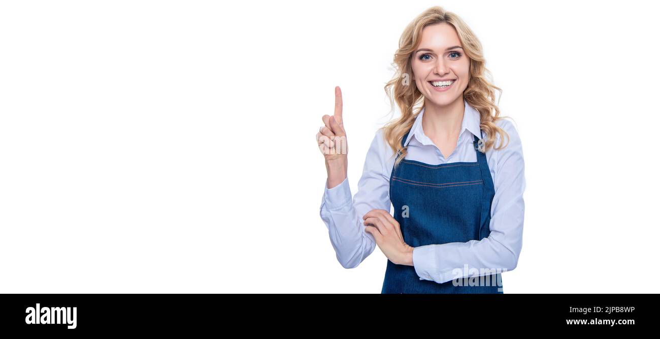 bonne femme de serveur dans le doigt de point de tablier isolé sur fond blanc. Femme isolée visage portrait, bannière avec espace de copie de maquette. Banque D'Images