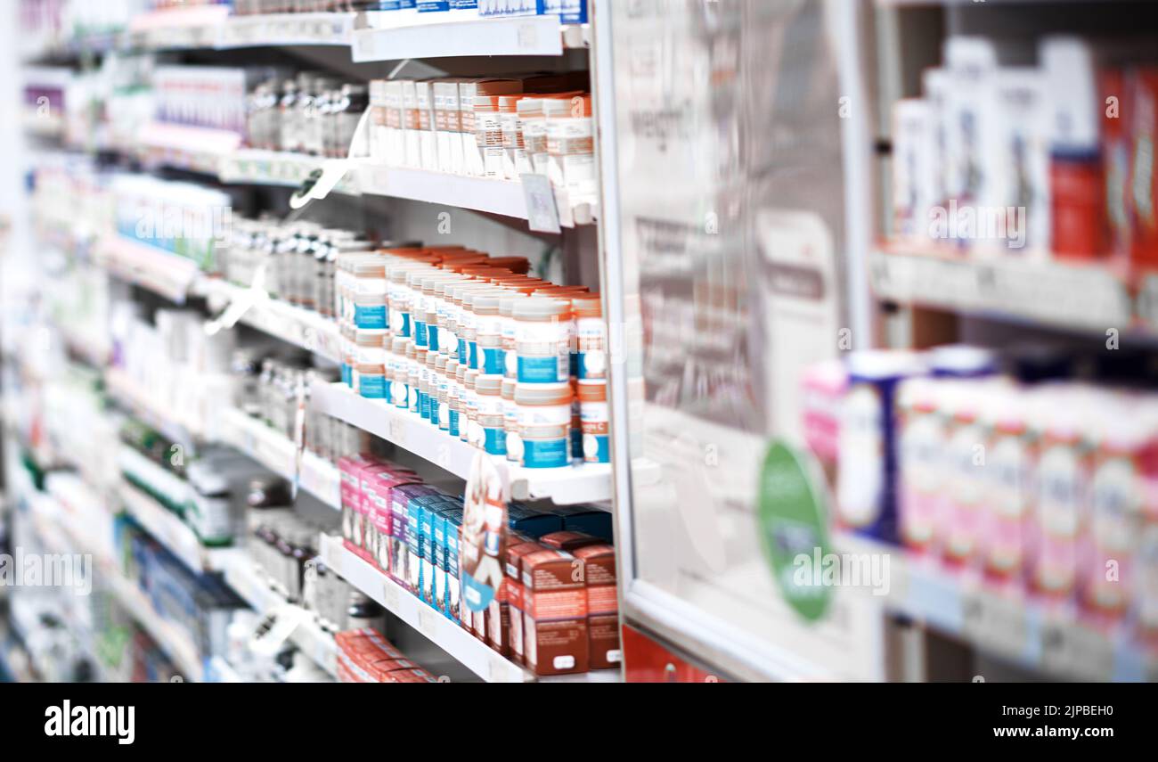 Bien trouver un traitement hors de notre étagère pour vous. Étagères garnies de divers médicaments dans une pharmacie. Banque D'Images