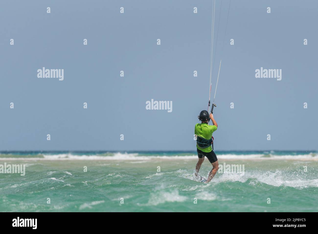 Homme apprenant kitesurf, homme à l'école de kiteboarding. Cours de kite surf dans les îles Canaries, Fuerteventura. Garçon faisant l'eau commencer au kite board Banque D'Images