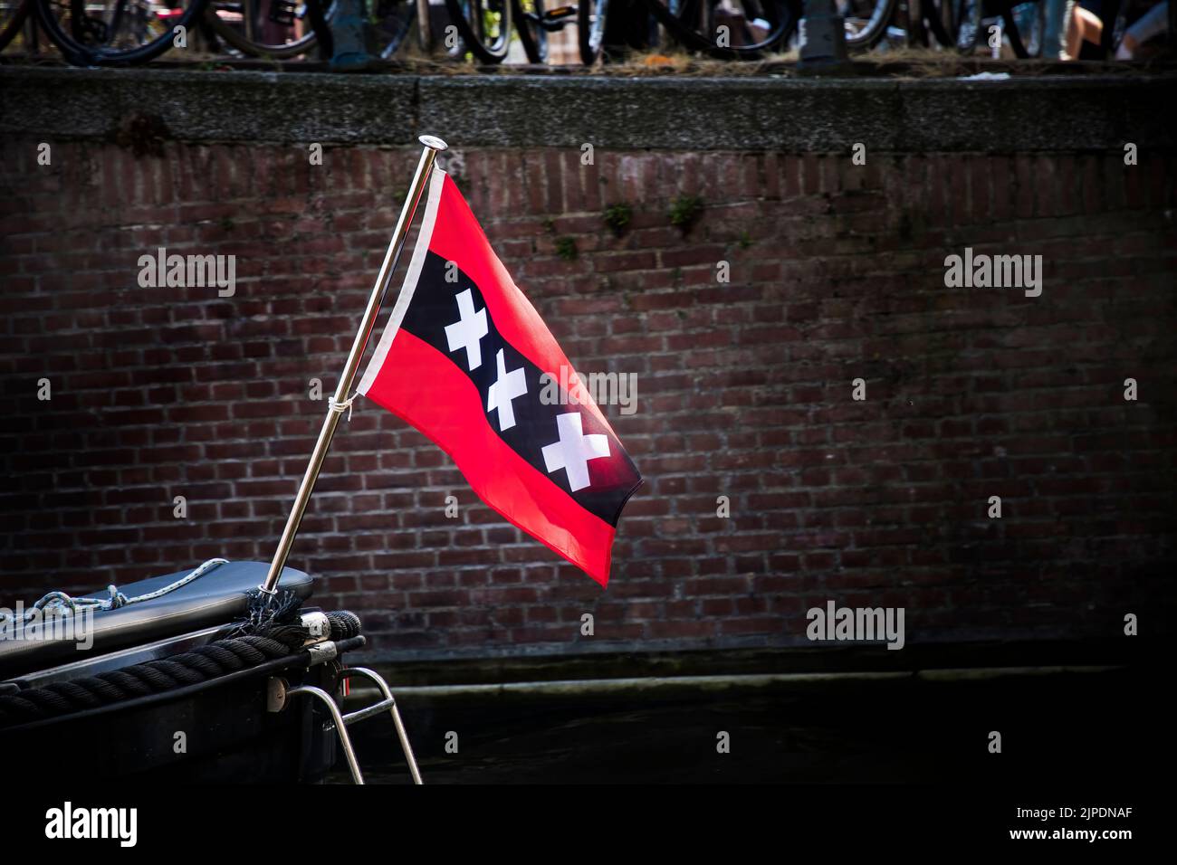 Drapeau d'Amsterdam à l'arrière du bateau sur le canal Banque D'Images