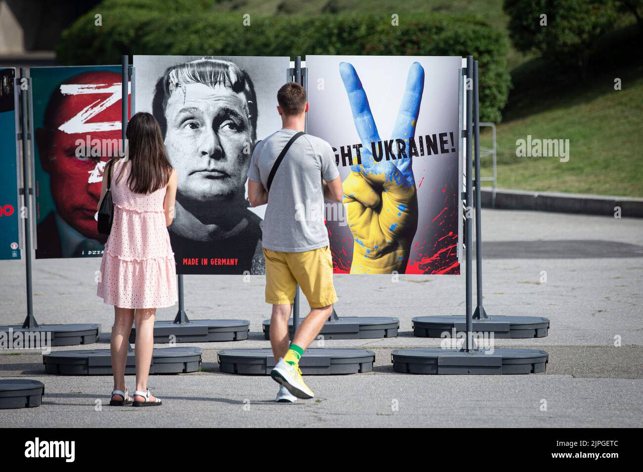 Kiev, Ukraine. 17th août 2022. Les gens regardent une affiche à l'image du président russe Vladimir Poutine lorsqu'ils visitent une exposition d'affiches en plein air intitulée « le jour de la victoire » au Musée national de l'histoire de l'Ukraine pendant la Seconde Guerre mondiale à Kiev. Les affiches créées par le peintre ukrainien Andrii Yarmolenko et l'artiste polonais Wojciech Korkuts reflètent principalement l'invasion de l'Ukraine par la Russie avec l'espoir de la victoire de l'Ukraine contre l'armée russe. Crédit : SOPA Images Limited/Alamy Live News Banque D'Images