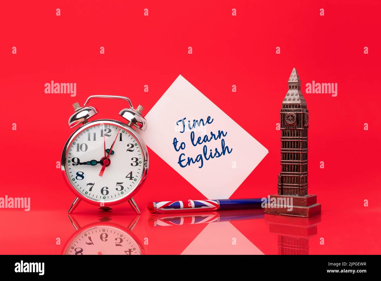 Il est temps d'apprendre l'anglais. Stylo avec le drapeau du Royaume-Uni sur fond rouge à côté d'une horloge et d'une carte pour écrire des messages. Étudier une nouvelle langue Banque D'Images