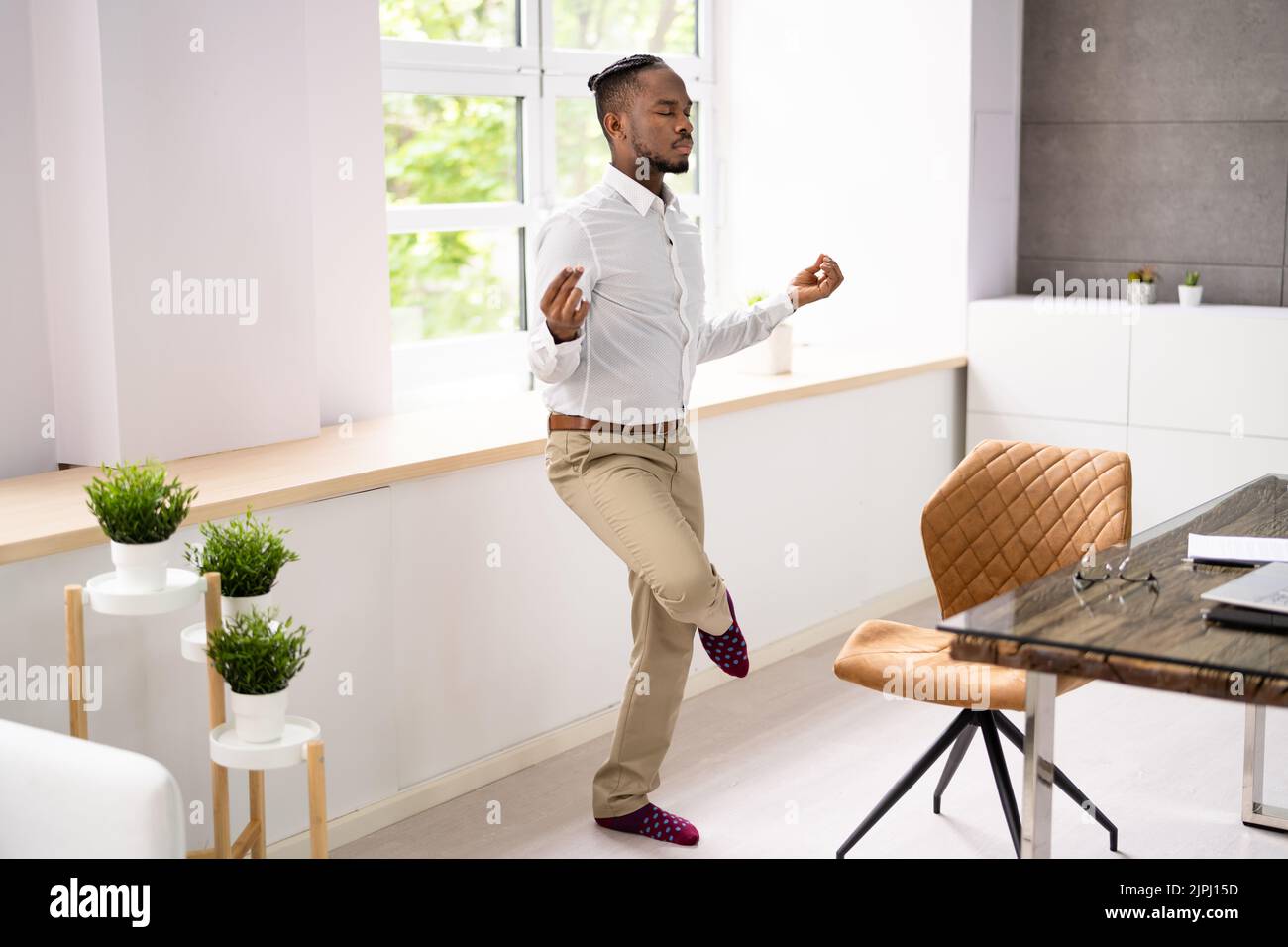 Un employé africain faisant de la santé mentale Yoga Méditation en bureau Banque D'Images