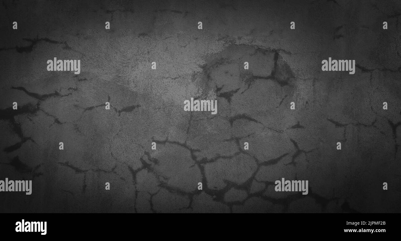 Vieux mur de ciment gris avec des fissures sur la surface. Banque D'Images