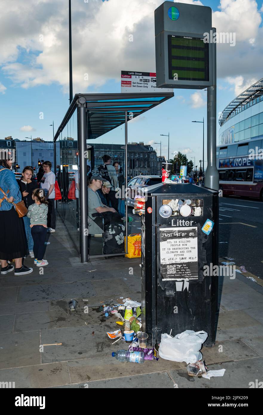 Édimbourg, Écosse, Royaume-Uni, 20th août 2022. Bac à litière débordant par des personnes qui attendent à un arrêt de bus dans Leith Street pendant la grève: Le troisième jour de la grève des binmen, un bac à ordures par un arrêt de bus est débordant de litière s'accumuler autour de lui. Crédit : Sally Anderson/Alay Live News Banque D'Images