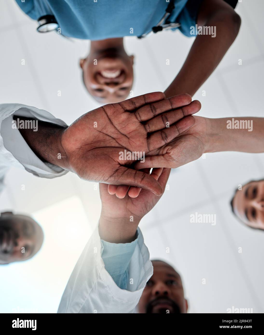 But d'un groupe de médecins avec leurs mains ensemble dans le soutien, l'unité et la confiance ensemble prêt pour la chirurgie à l'hôpital. Vue en dessous de l'équipe médicale ou Banque D'Images