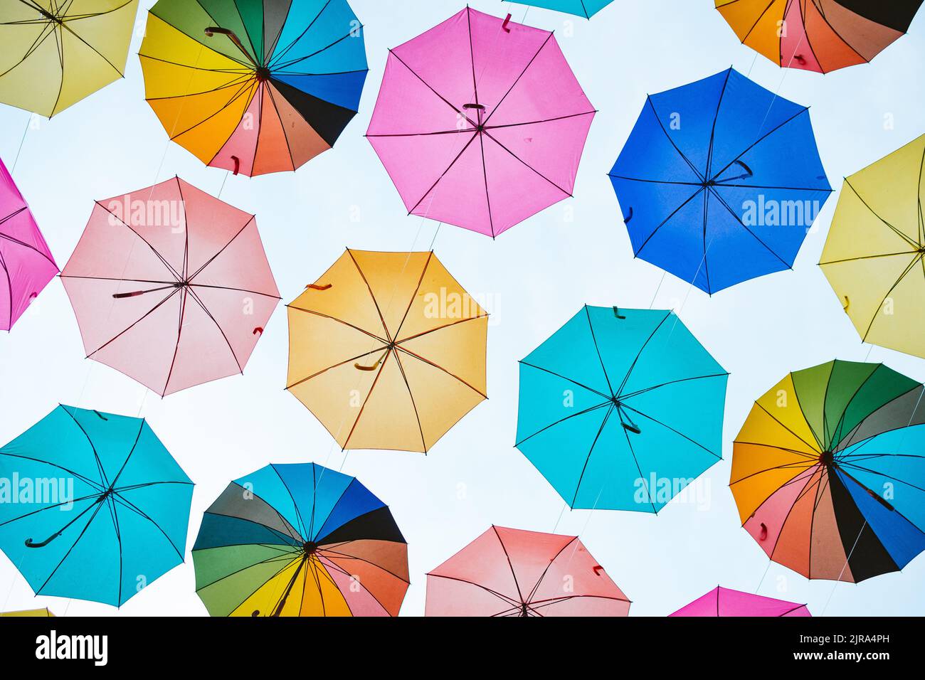 Parasols colorés. Parasols colorés suspendus dans le ciel utilisé comme décoration de rue. Banque D'Images