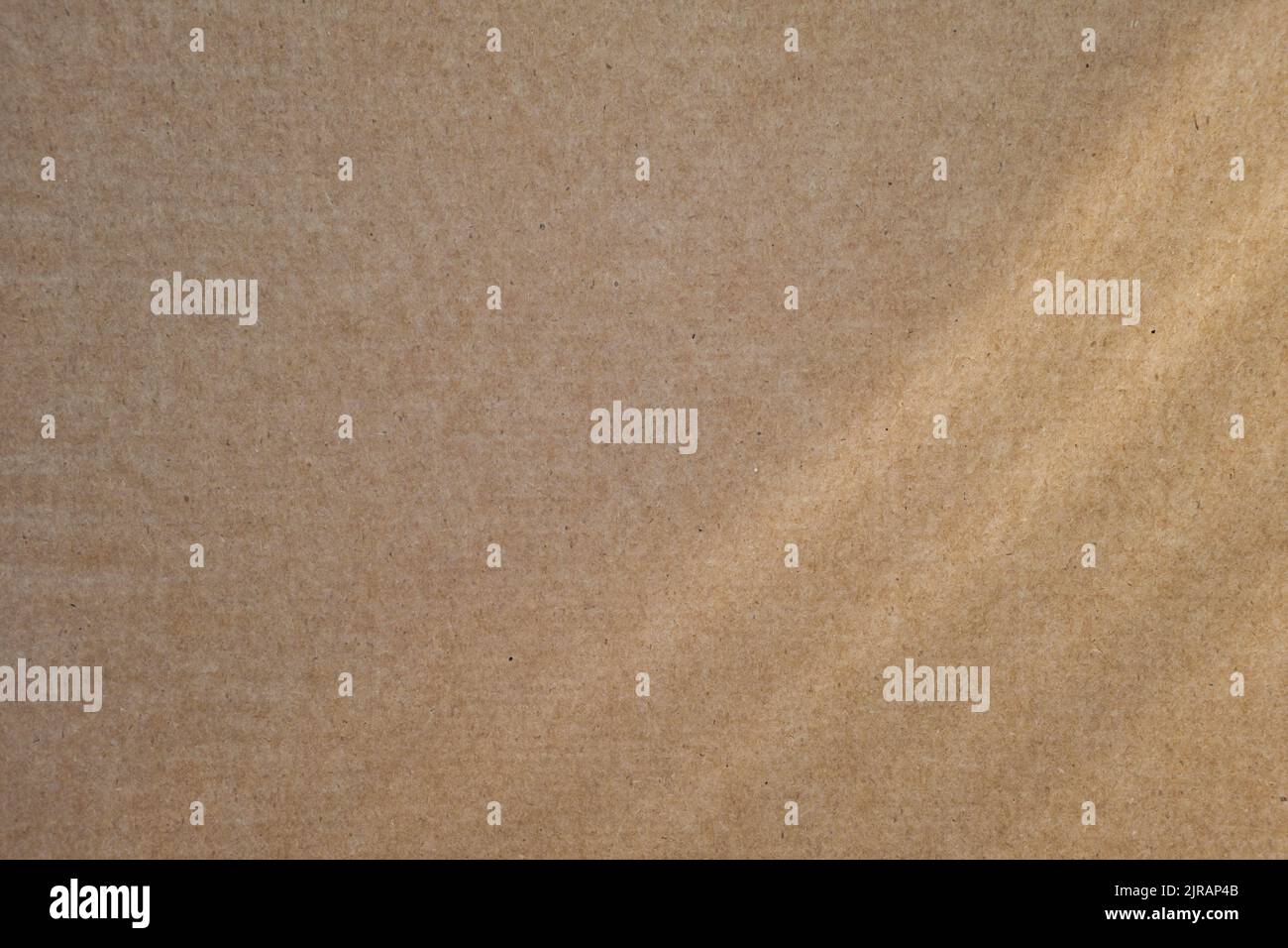 Texture en carton beige vierge avec rayons de soleil. Arrière-plan abstrait. Papier recyclé, matières premières écologiques. Banque D'Images