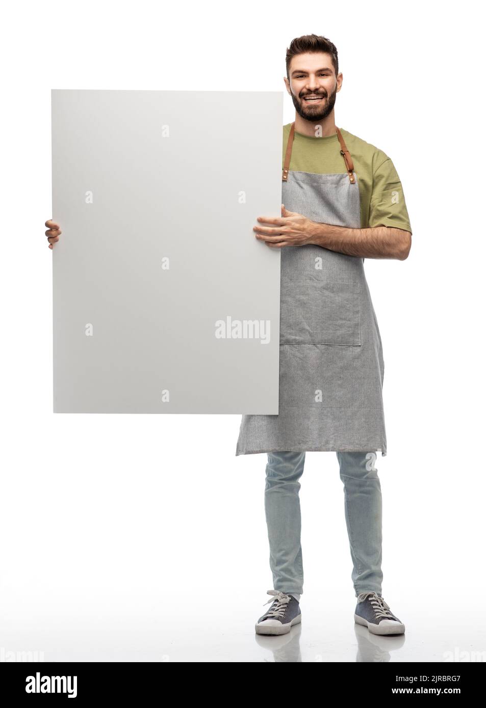 bon barman dans un tablier tenant un tableau blanc vide Banque D'Images
