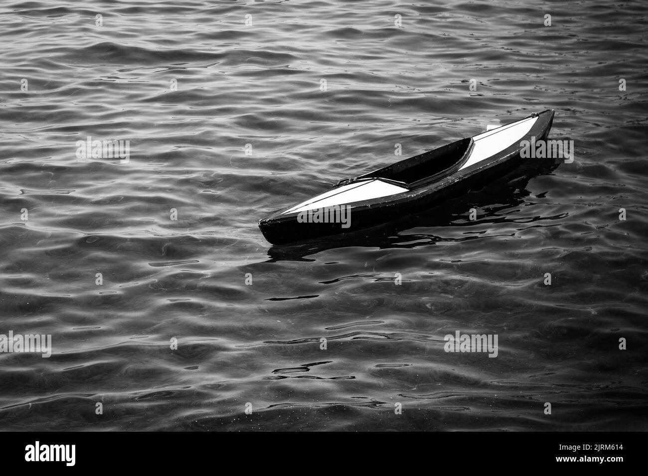 Une photo en niveaux de gris d'un kayak sur l'eau Banque D'Images