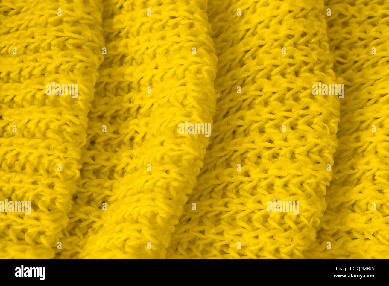 Texture de tissu tricoté jaune doux comme arrière-plan. Bannière pour le design Banque D'Images