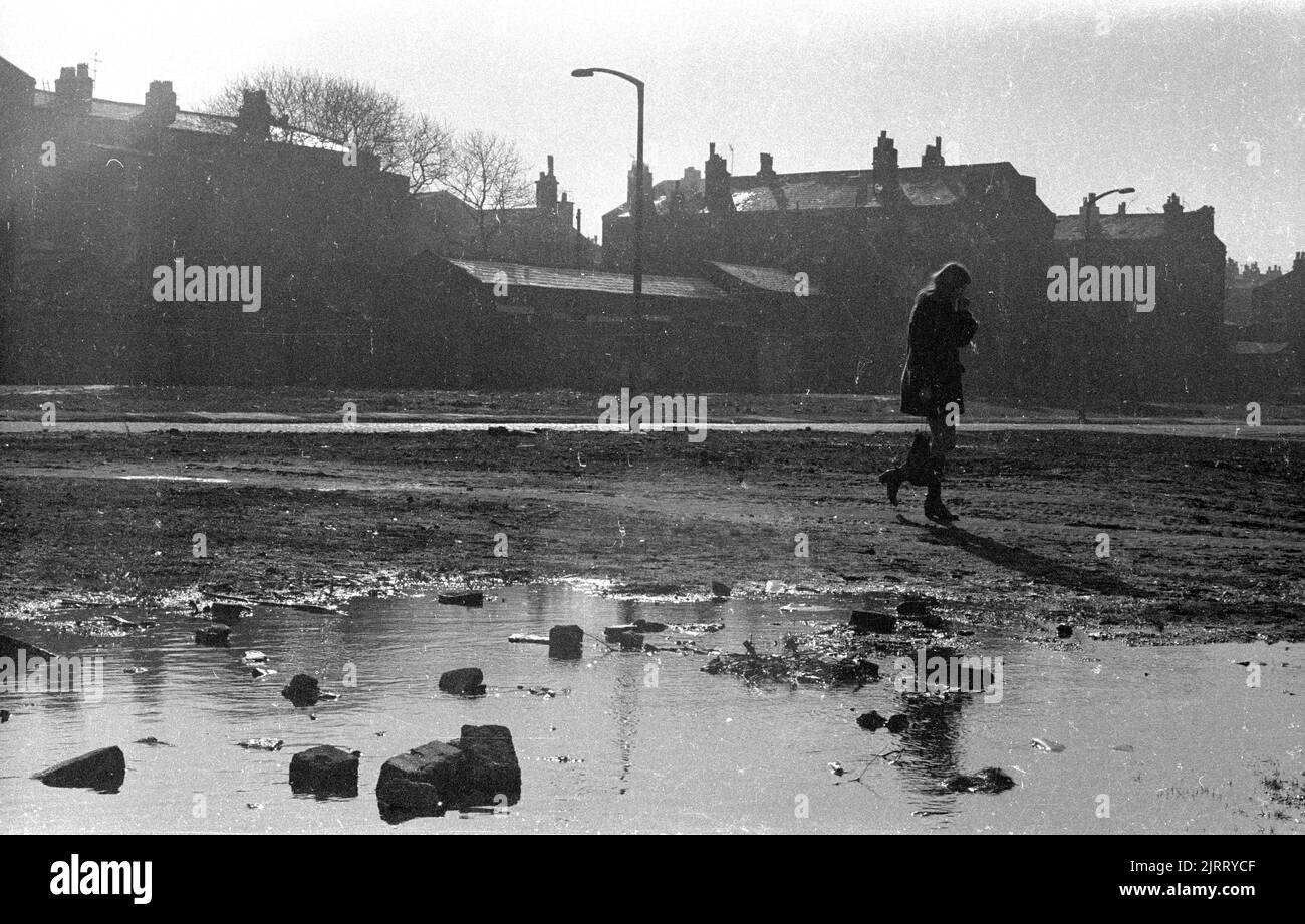 Une jeune femme qui marche à travers les déchets, centre-ville de Liverpool, Royaume-Uni. 1970 Banque D'Images