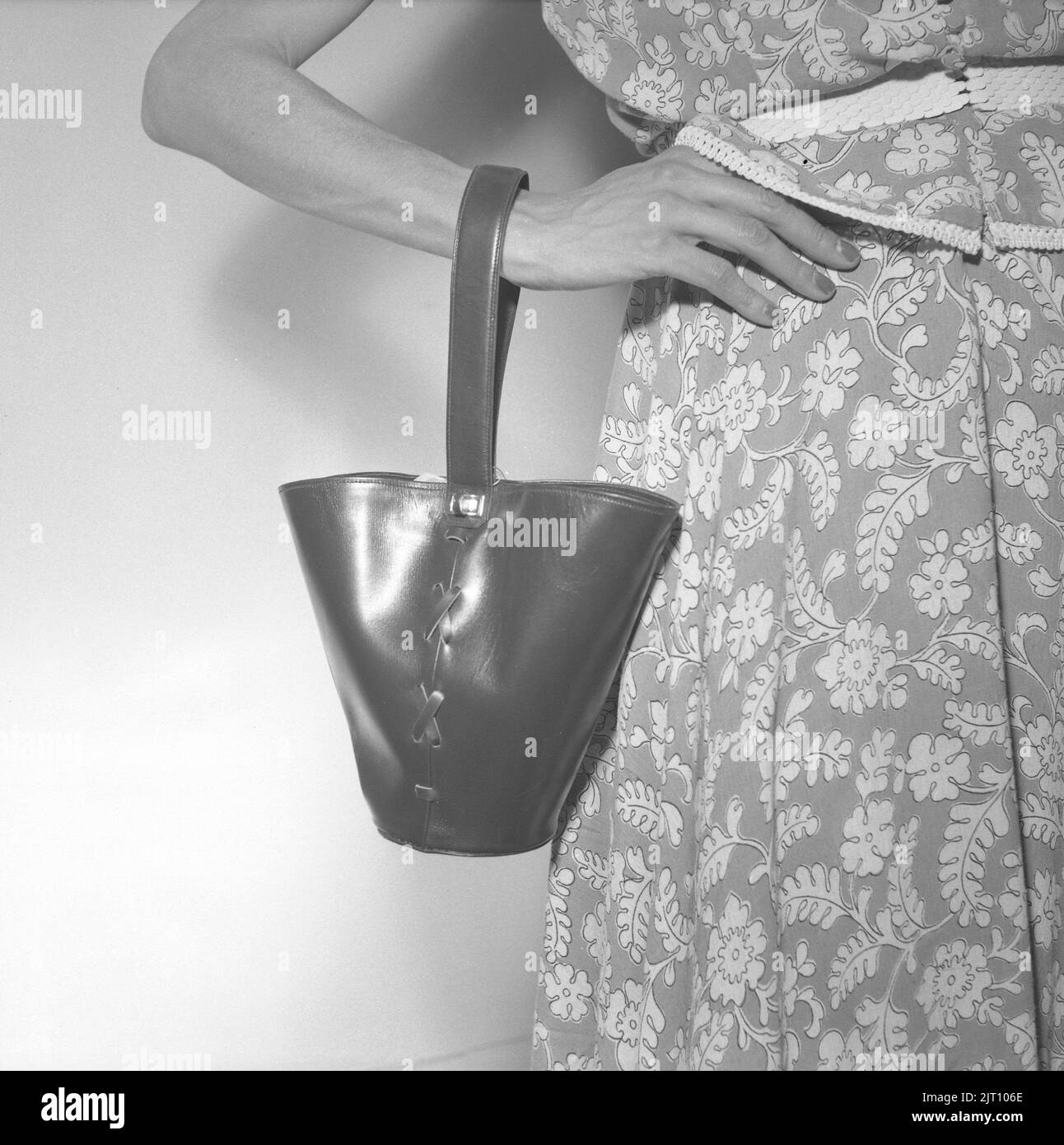 La mode des femmes en 1950s. Une jeune femme avec un sac à main dans la conception de l'année 1952, présenté à un salon comme la dernière en mode sac à main. Suède 1952 Conard réf. 2112 Banque D'Images