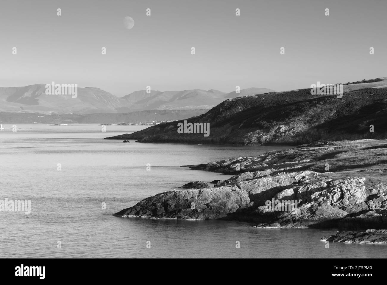 Vue de point Lynas en direction de Snowdonia. Anglesey, pays de Galles du Nord, Royaume-Uni. Banque D'Images