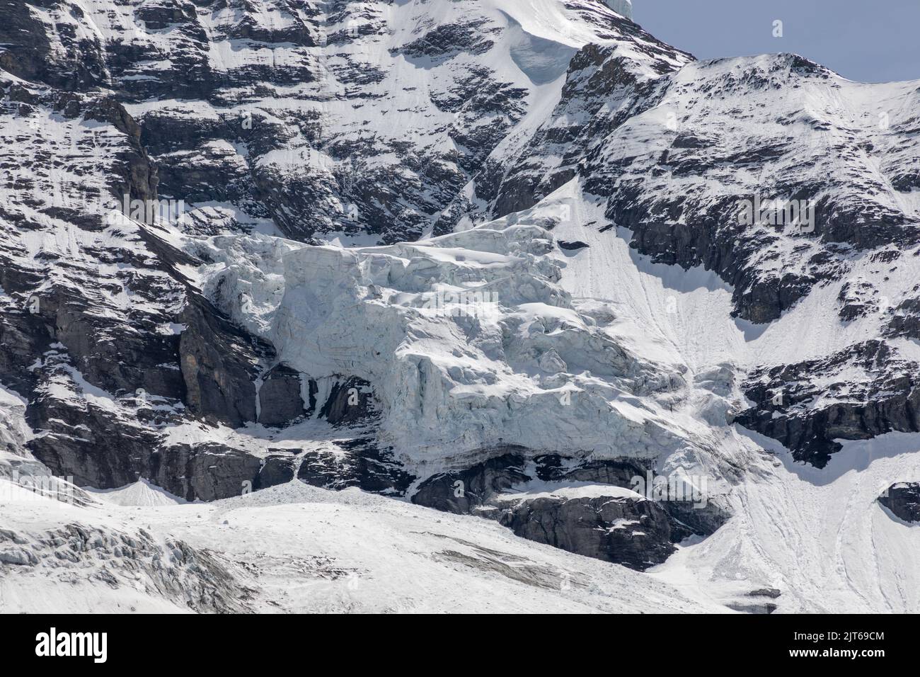 Le glacier se couche de glace au bord du sommet de la montagne Mönch en Suisse. Banque D'Images