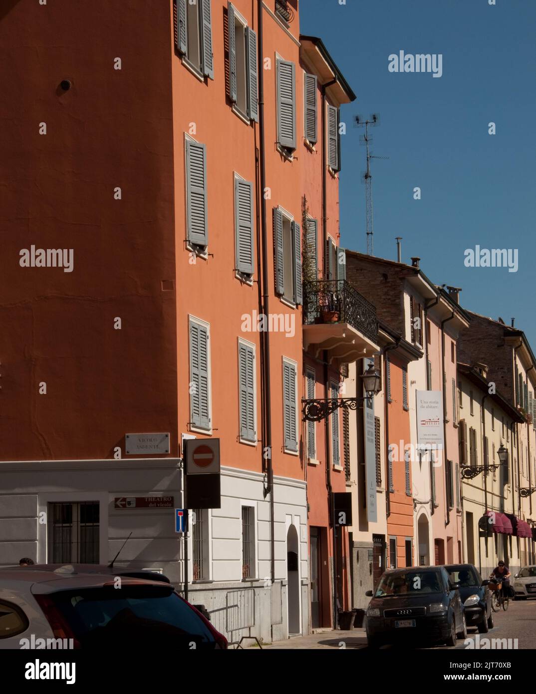 Scène de rue, Parme, Emiglia Romagna, Italie. Maisons peintes dans des couleurs vives avec volets et balcons. Banque D'Images