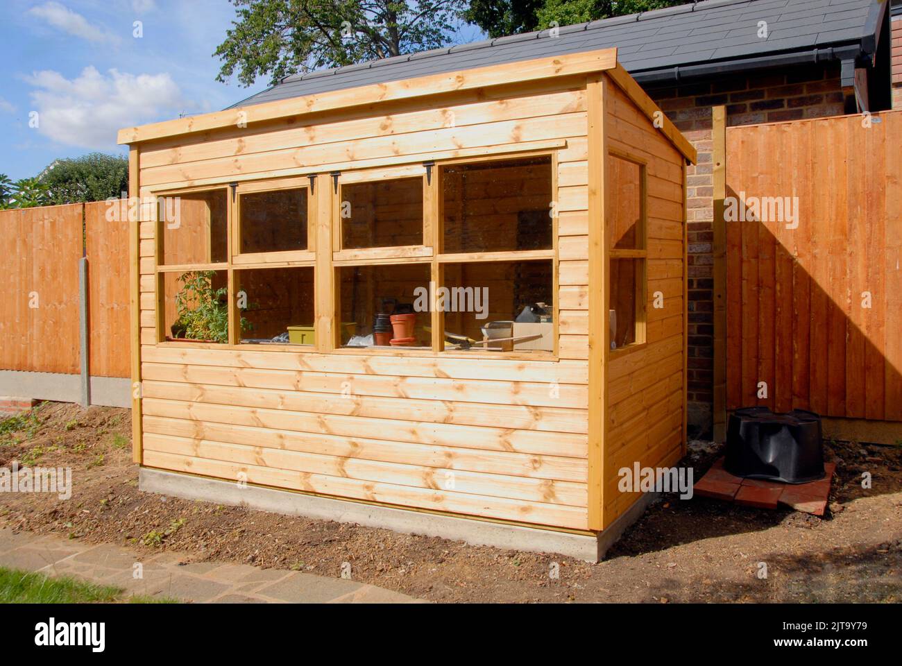 Hangar en pot de jardin en bois avec fenêtres fermées Banque D'Images