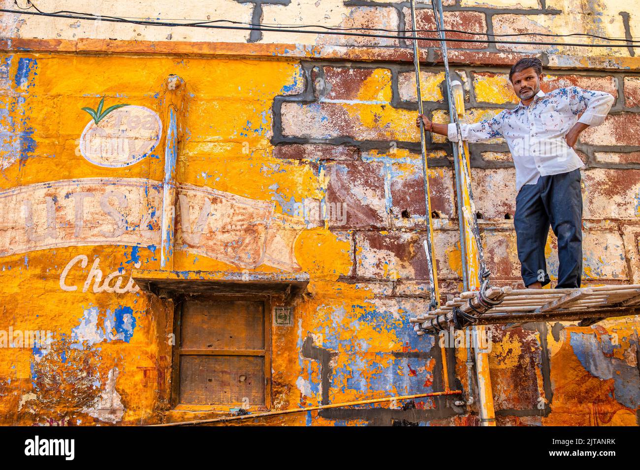 Peintre en face d'une maison colorée, Rajasthan, Inde Banque D'Images