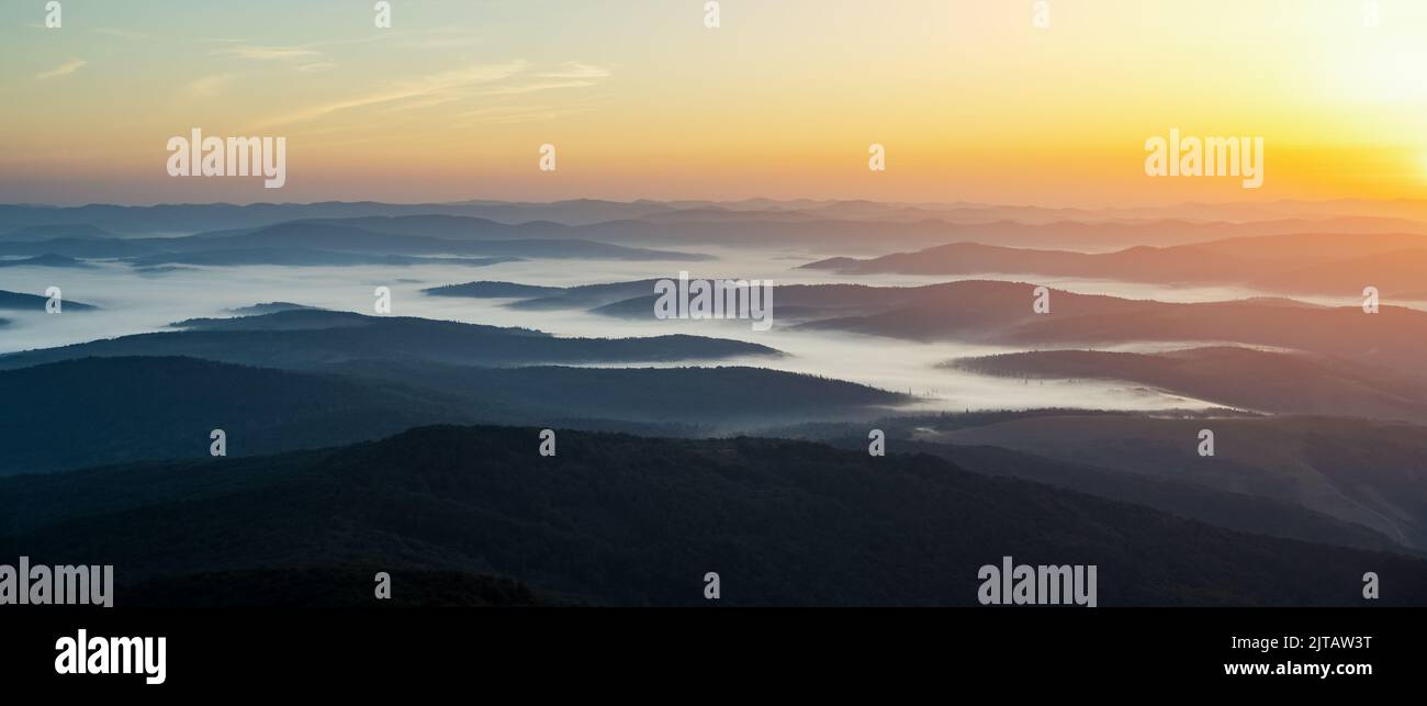 Brouillard matinal dans les montagnes d'automne. Magnifique lever de soleil en arrière-plan. Panorama de la photographie de paysage Banque D'Images