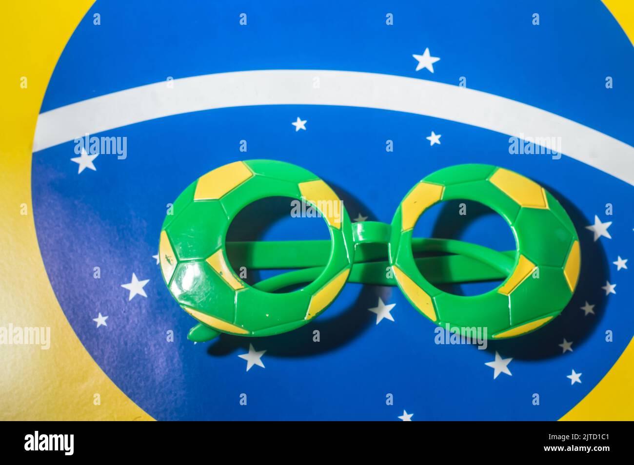 Lunettes aux couleurs du Brésil, jaune et bleu vert, concept de la coupe du monde avec fond jaune. Banque D'Images