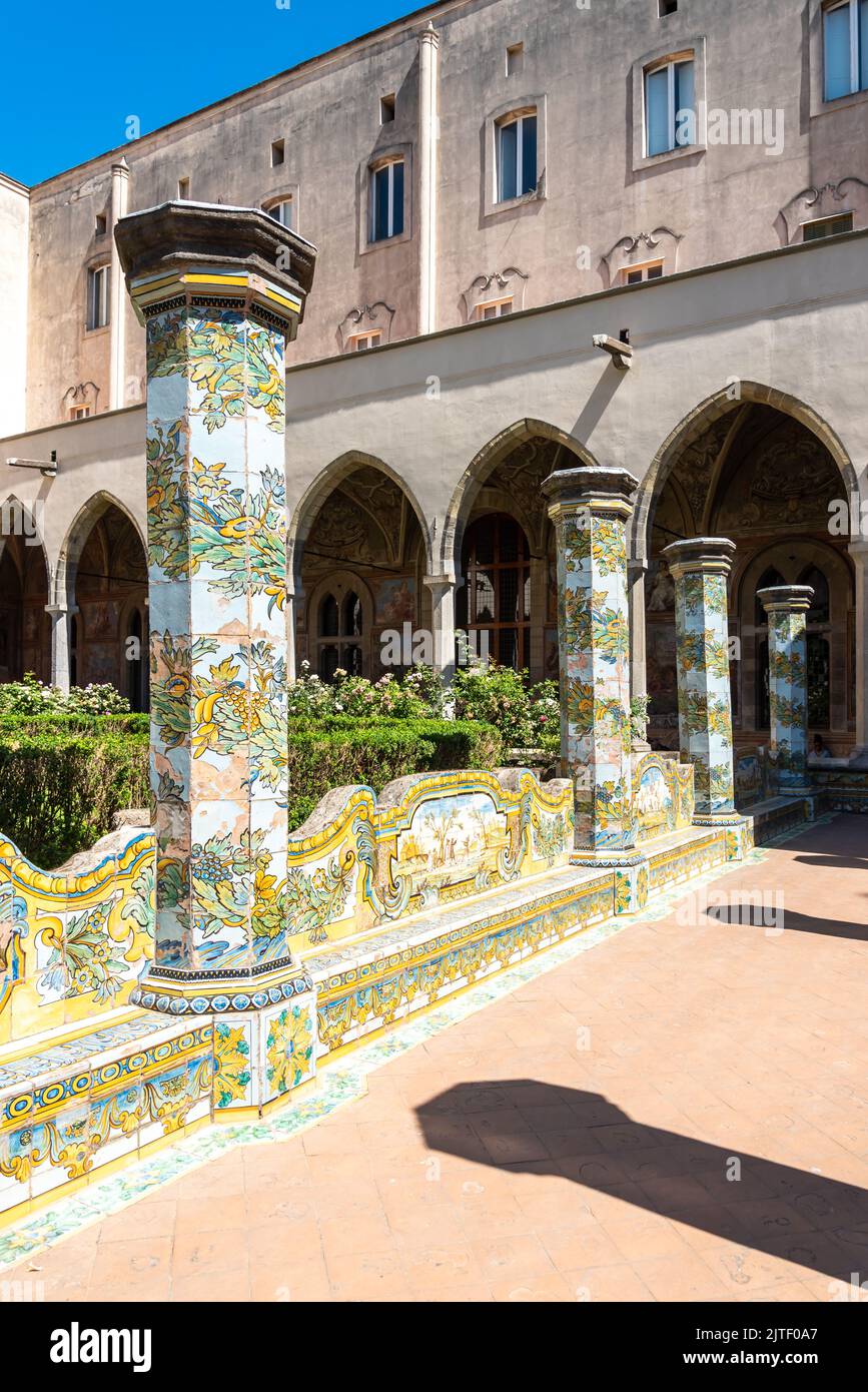 Colonnade aux carreaux colorés décorant le jardin à l'intérieur du monastère de Naples, Italie Banque D'Images