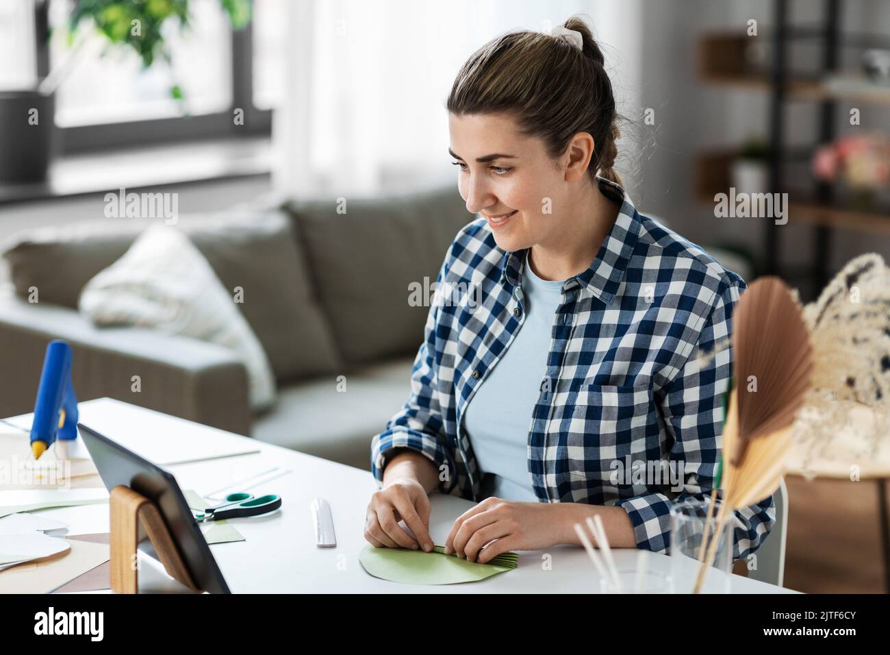 femme avec un tablet pc qui fait du papier à la maison Banque D'Images