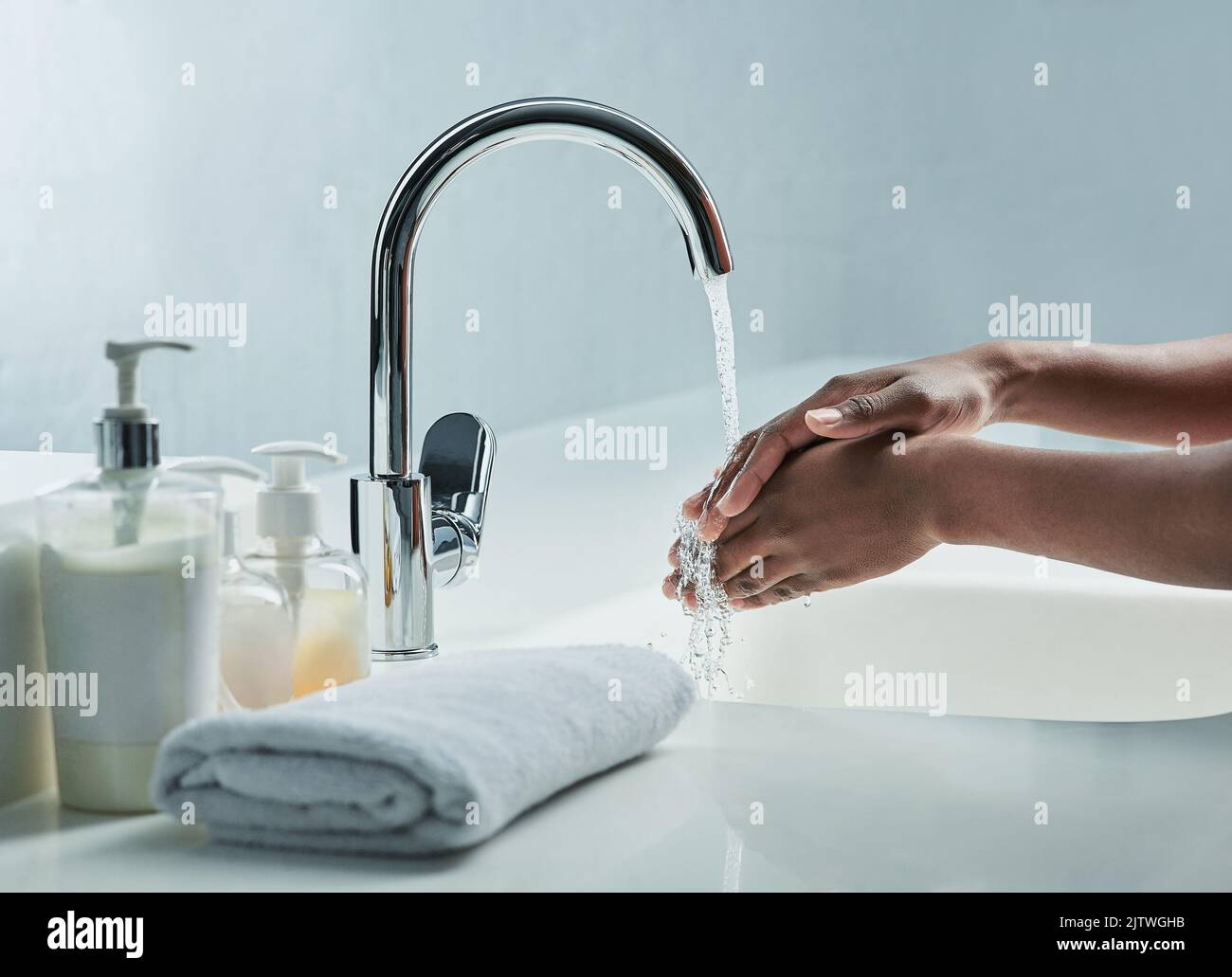 Dites goodby aux bactéries. Un homme se lavant les mains dans un lavabo de salle de bains. Banque D'Images