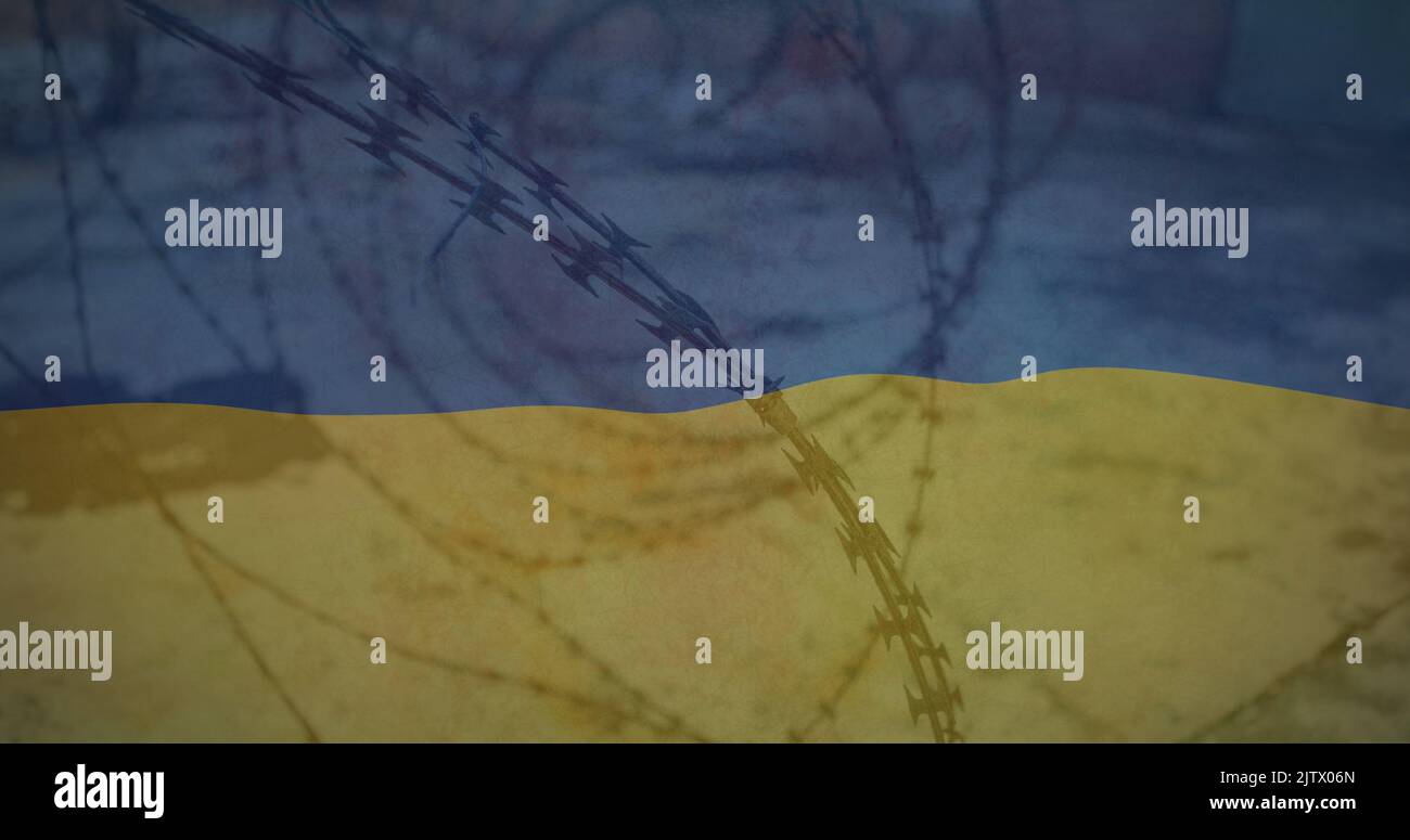 Image du drapeau de l'ukraine sur le terrain et le fil barbelé Banque D'Images