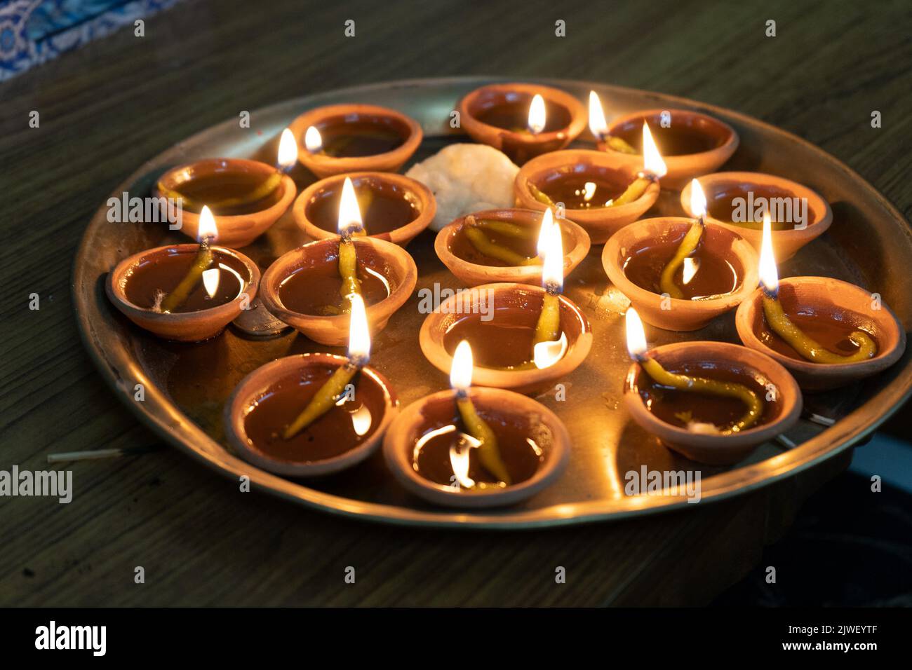 Plaque en laiton remplie de diyas de terrassement remplies d'huile et une mèche en coton éclairée pour la lumière Banque D'Images