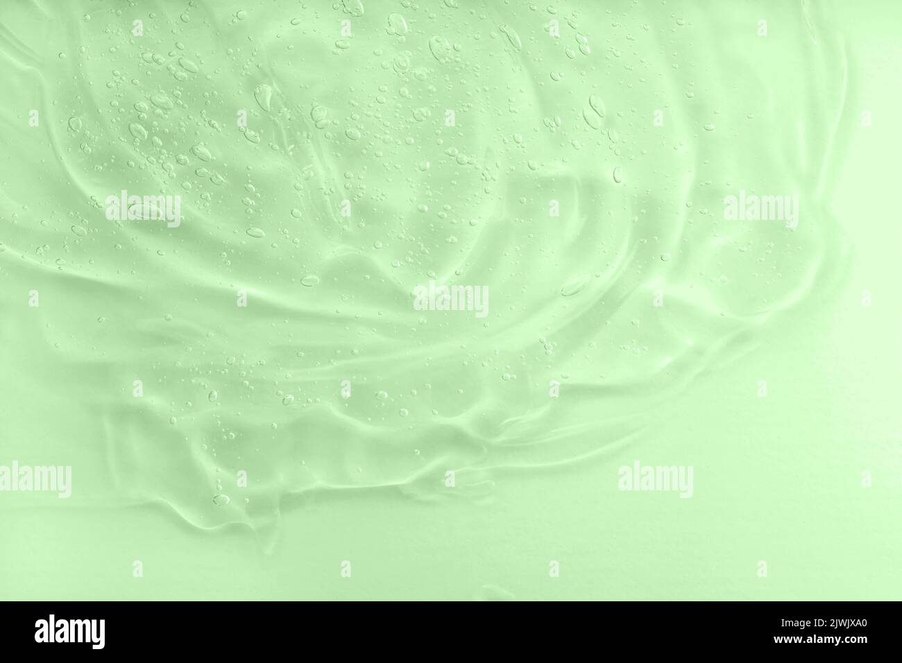 Texture de gel cosmétique Aloe vera avec fond de bulles. Produit hydratant pour le soin de la peau. Taches d'huile verte liquide. Le concept de cosmétiques naturels Banque D'Images