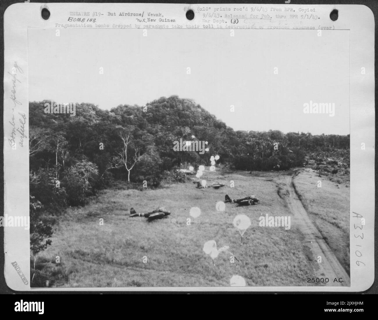 Les bombes de fragmentation larguées par le parachute ont fait des ravages dans la destruction des avions japonais mis à la terre et des installations sur l'aérodrome de but. Ce raid a été l'un des coups lourds a occupé l'ennemi récemment dans les régions de but et de Wewak. Banque D'Images