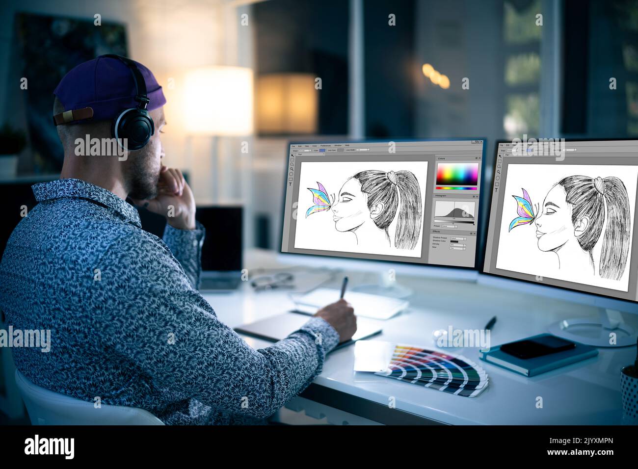 Graphiste travaillant tard dans la nuit au bureau Banque D'Images