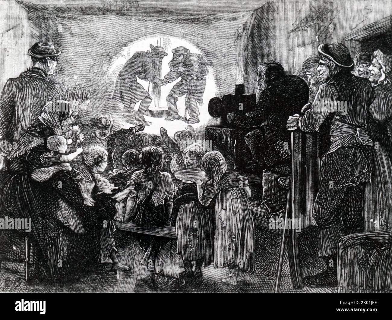 Les enfants du East End de Londres profitent d'un spectacle de lanternes magiques. Banque D'Images Les enfants du East End de Londres profitent d'un spectacle de lanternes magiques. Banque D'Images