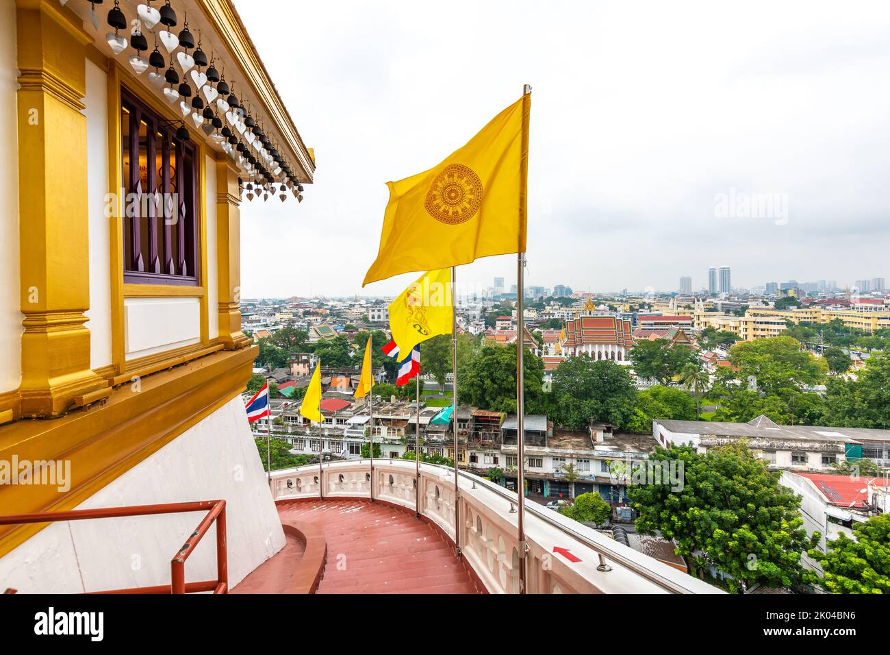 Vue depuis le temple de Wat Saket à Bangkok, Thaïlande. Détail des drapeaux sur le dessus du Golden Mount. Drapeau national de la Thaïlande avec drapeau du bouddhisme. Dans un paysage urbain lointain o Banque D'Images
