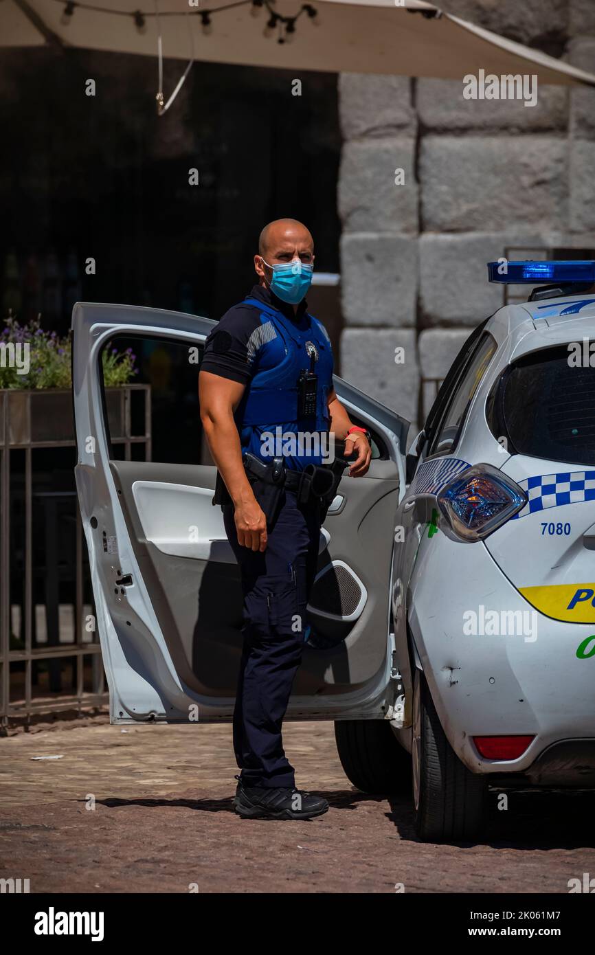 Madrid, Espagne - 28 juin 2021: Policier en uniforme et masque COVID 19 par une voiture de police municipale, Renault Zoe électrique sur la place Mayor Banque D'Images
