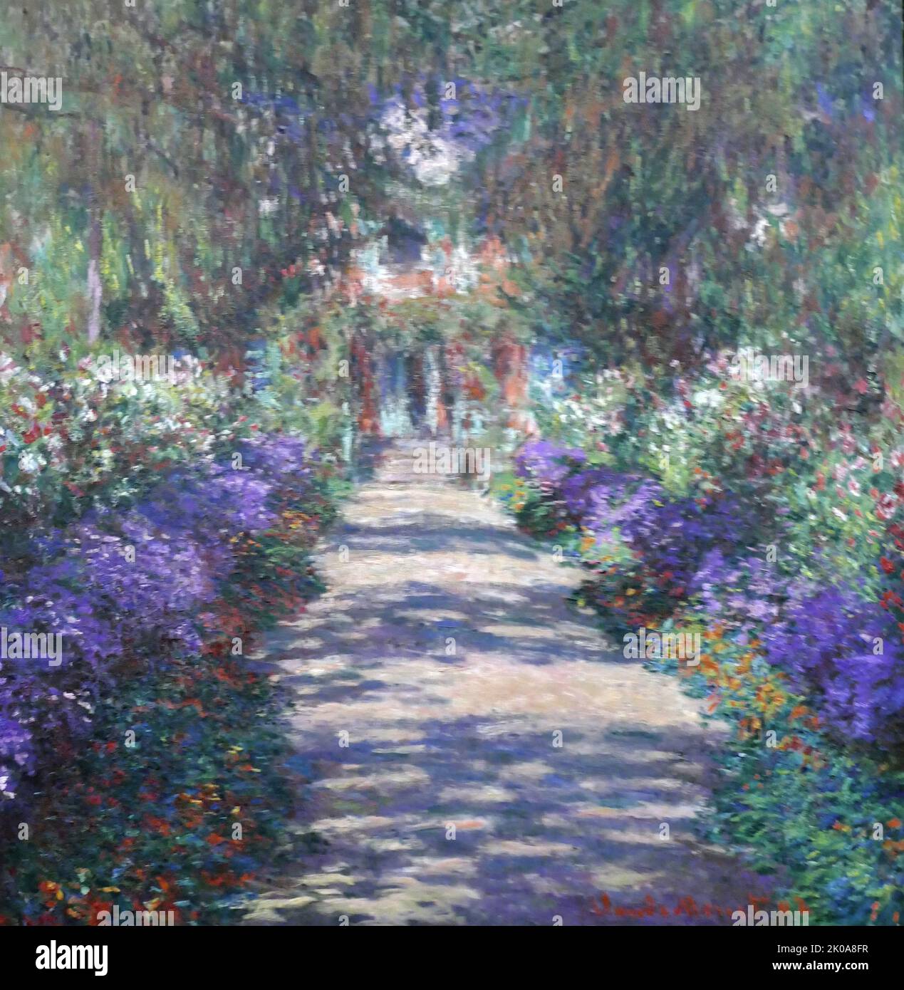 Chemin dans le jardin de Monet à Giverny, 1902. Oscar-Claude Monet (14 novembre 1840 - 5 décembre 1926) est un peintre français et fondateur de la peinture impressionniste qui est considéré comme un précurseur clé du modernisme, en particulier dans ses tentatives de peindre la nature telle qu'il l'a perçue. Banque D'Images