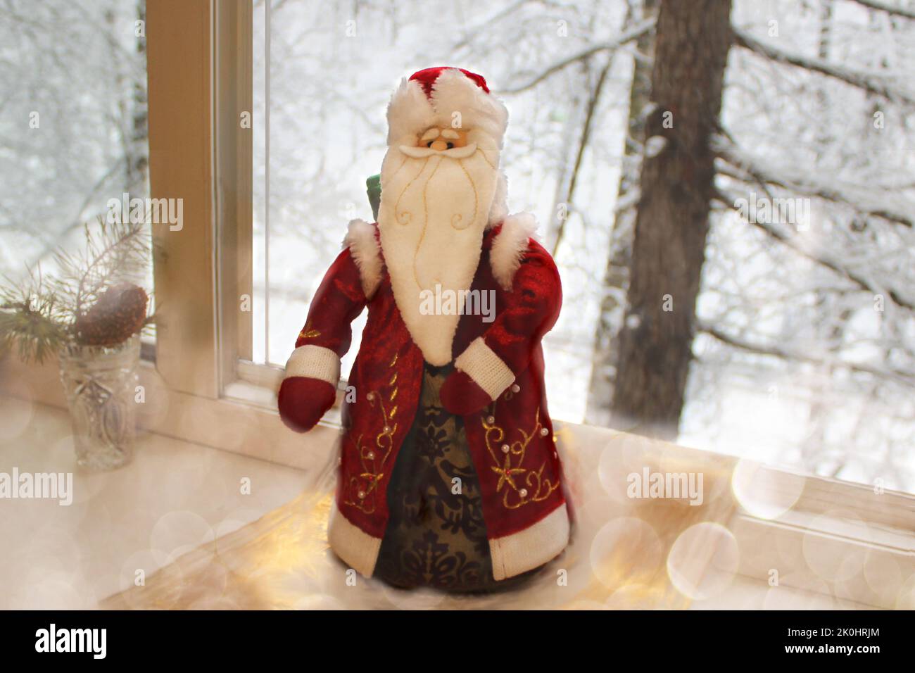 Le Père Noël en fourrure rouge sur fond de paysage enneigé d'hiver dans une fenêtre ouverte a volé pour féliciter le nouvel an et Noël pour un fes Banque D'Images