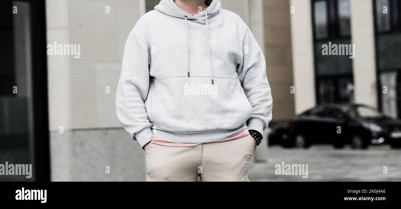 Portrait urbain homme portant un sweat à capuche gris vierge. Maquette pour impression Banque D'Images
