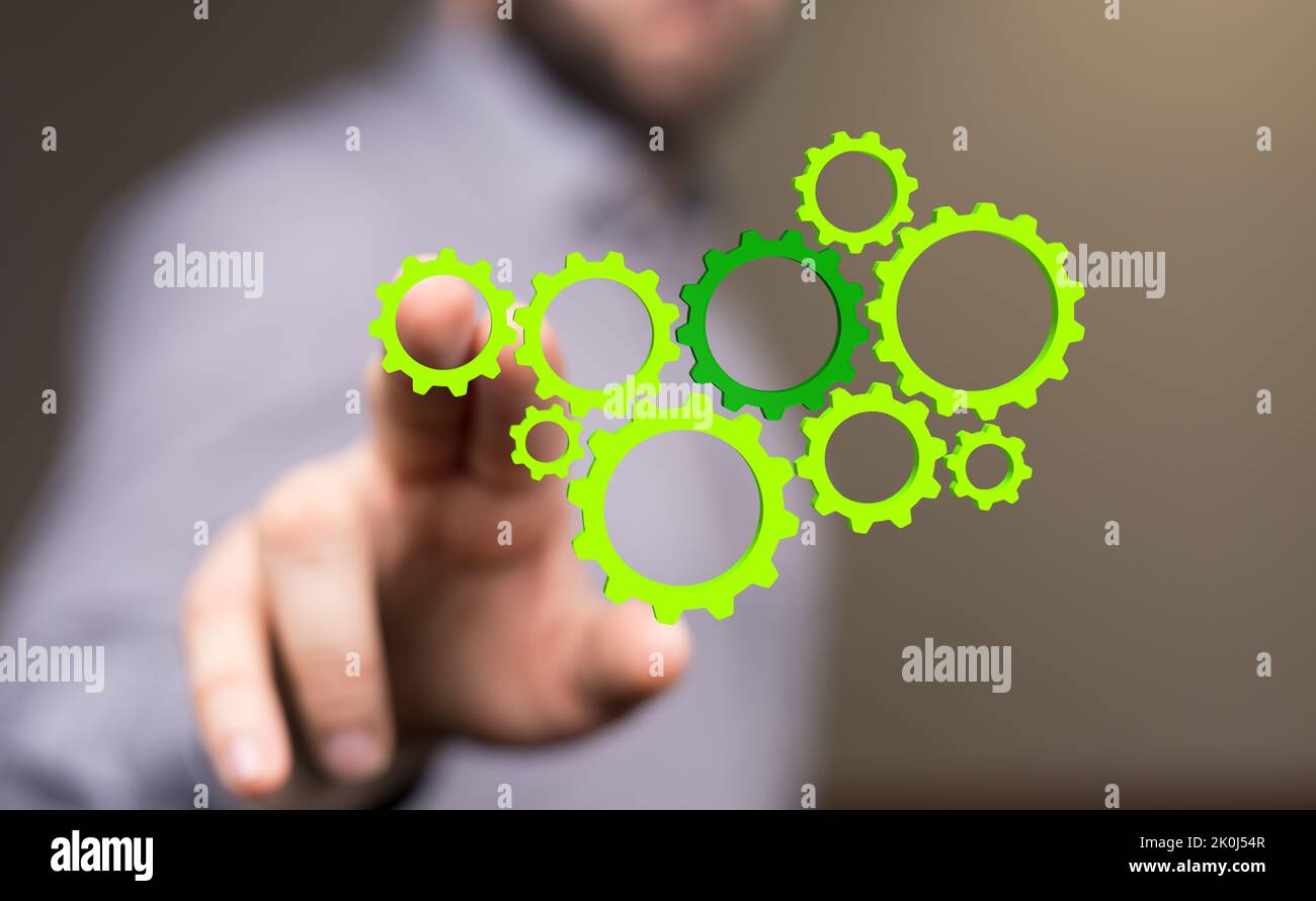 Un homme qui atteint les engrenages verts illustrés Banque D'Images