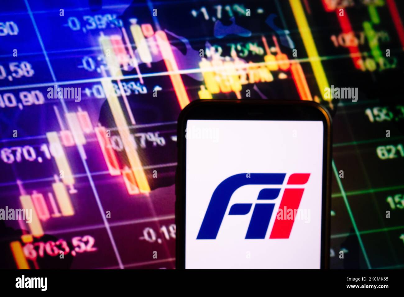KONSKIE, POLOGNE - 10 septembre 2022: Smartphone affichant le logo de la société Foxconn Industrial Internet sur fond de diagramme boursier Banque D'Images