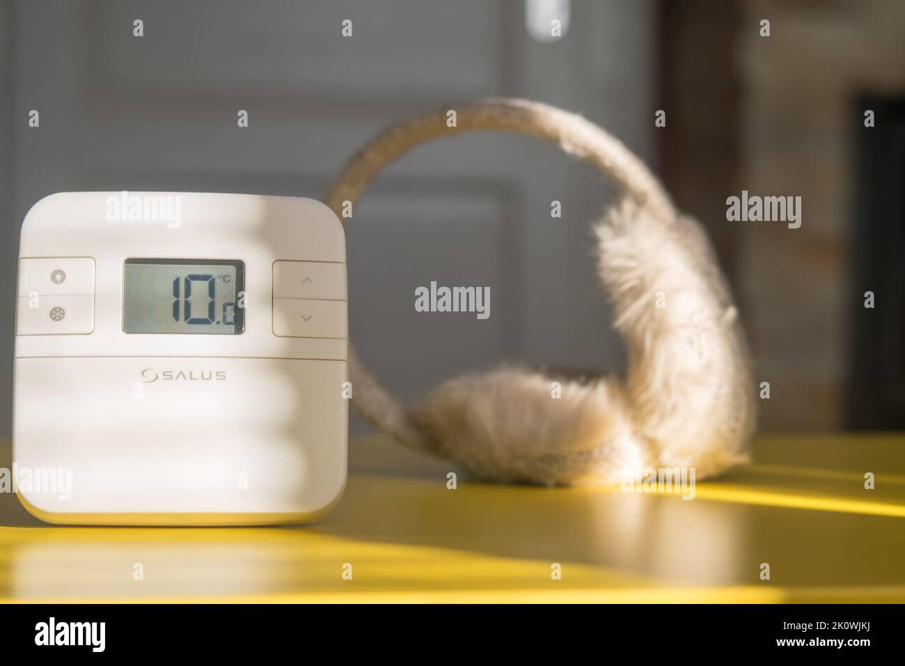 Thermostat d'origine réglé pour maintenir la température la plus basse. Concept de crise du gaz, de l'électricité et de l'énergie. Chapeau d'hiver mis de côté comme concept de froid. Banque D'Images