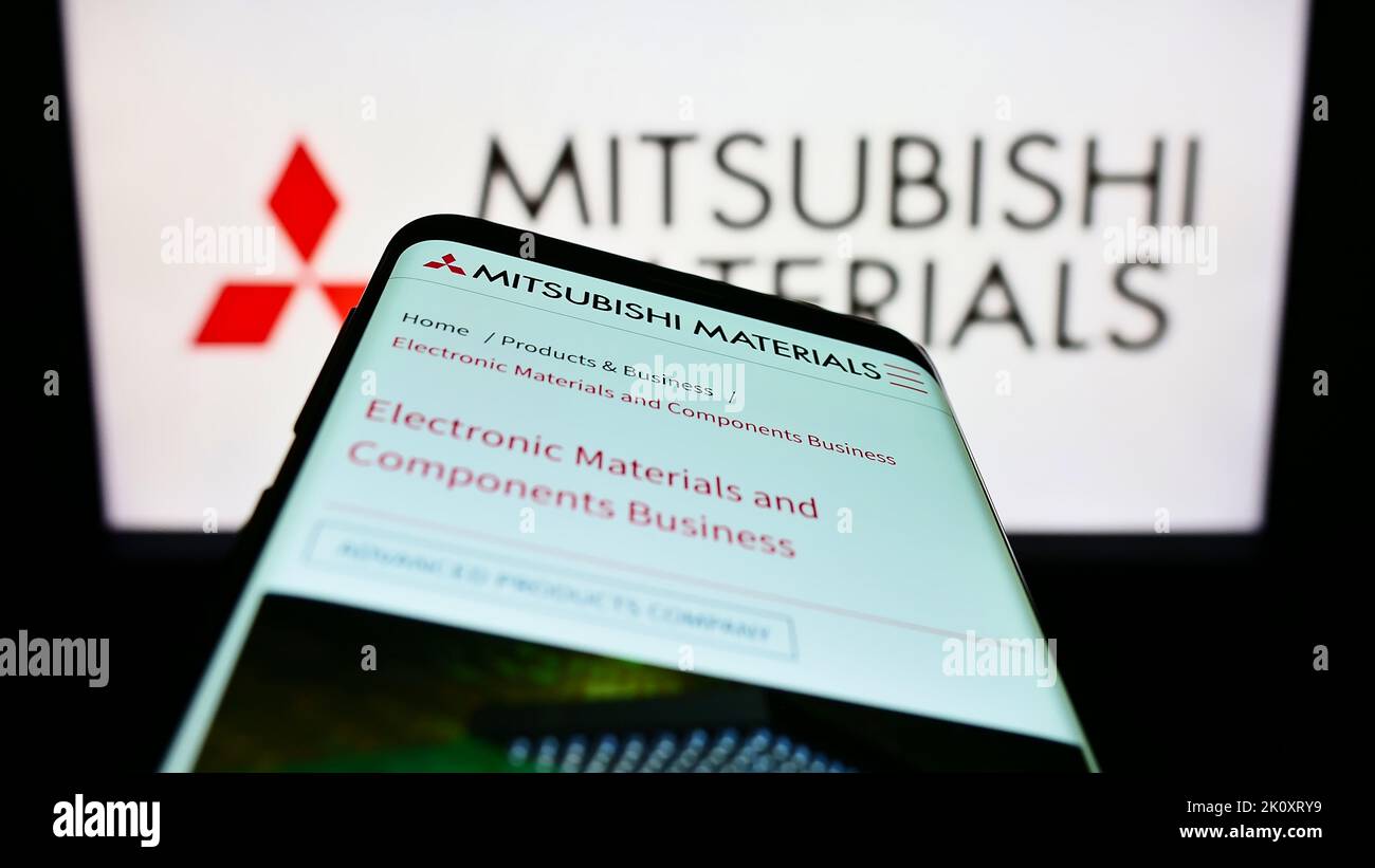 Téléphone mobile avec page Web de la société Mitsubishi Materials Corporation (MMC) à l'écran devant le logo. Faites la mise au point dans le coin supérieur gauche de l'écran du téléphone. Banque D'Images