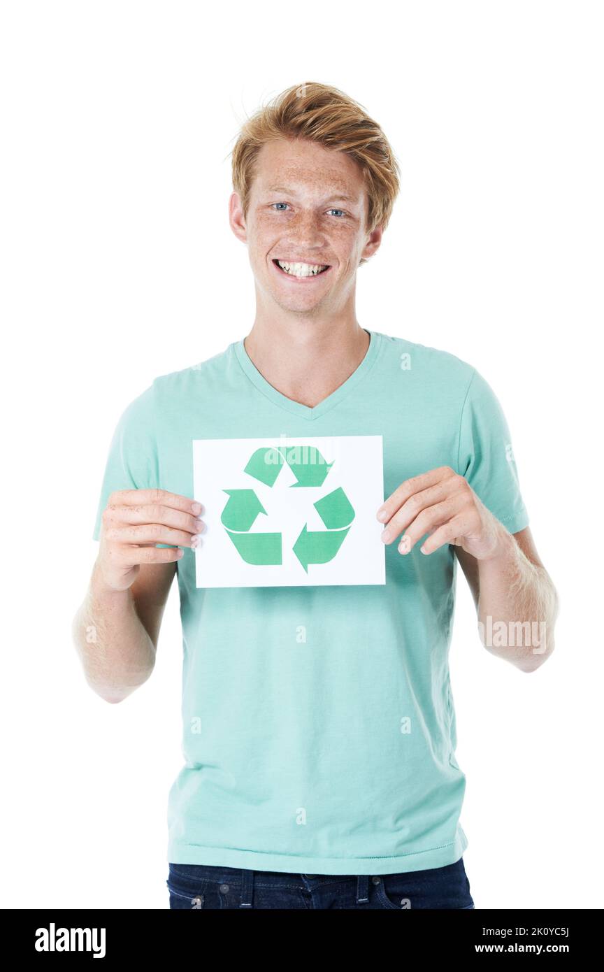 Prendre la responsabilité de nos déchets. Un jeune homme heureux à tête rouge tenant un panneau de recyclage - portrait. Banque D'Images