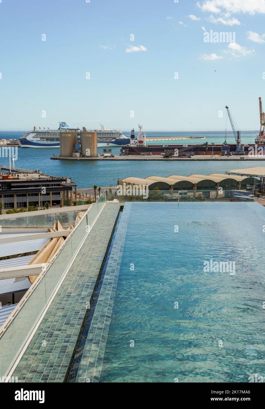 Petite piscine à débordement sur le toit de l'hôtel, avec le port de Malaga en arrière-plan, Costa del sol, Andalousie, Espagne. Banque D'Images