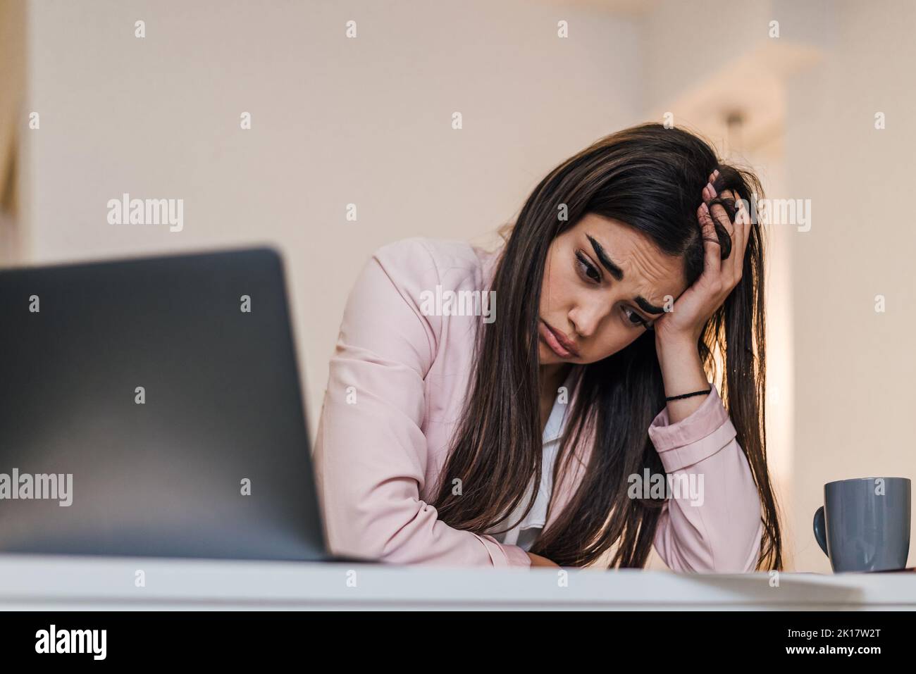 Jeune employé de brunette fatigué, travaillant dur et essayant de faire du brainstorming au bureau. Banque D'Images