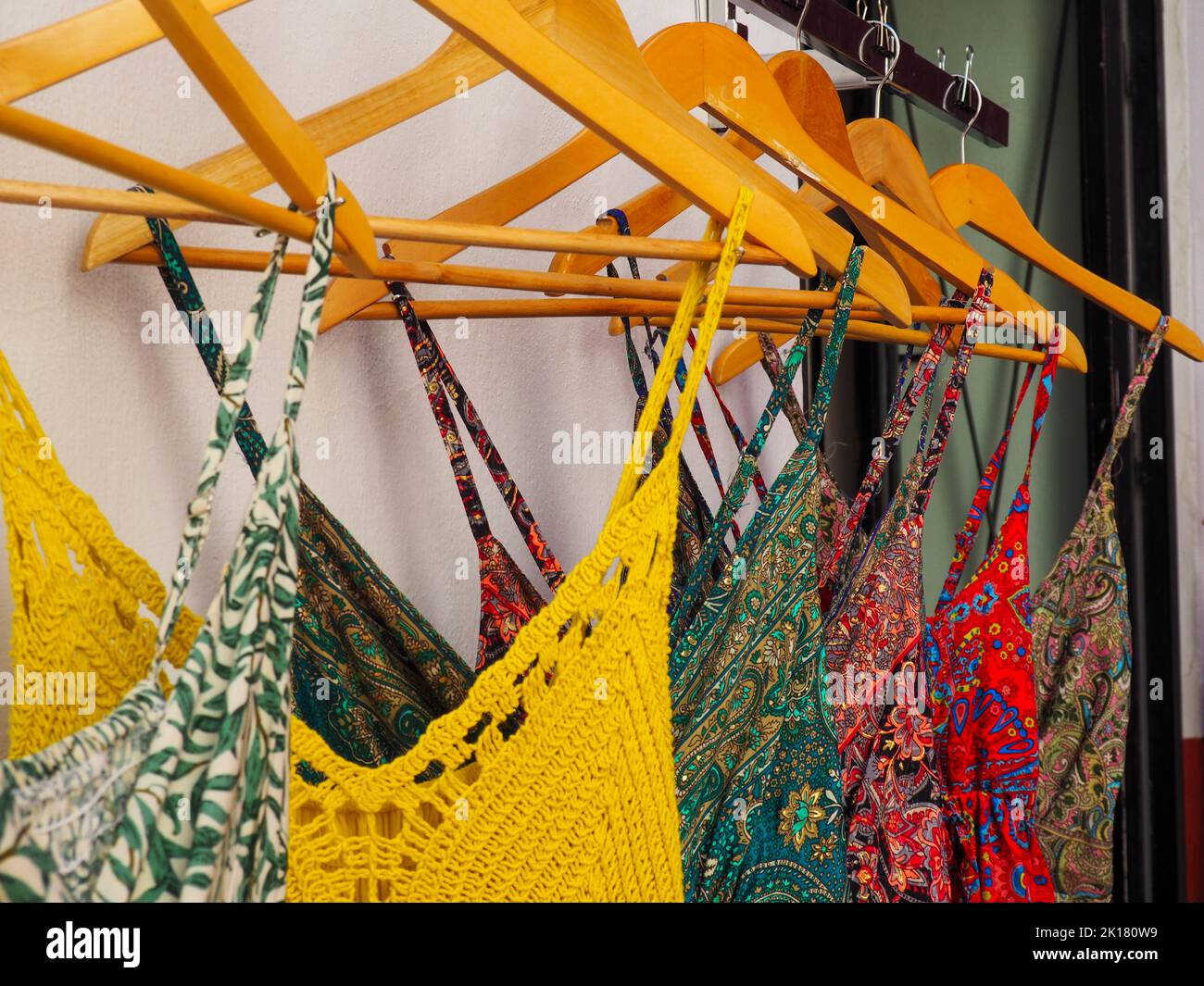 Ensemble de belles robes pour femmes de différentes couleurs affichées sur des cintres à vendre dans la rue Banque D'Images